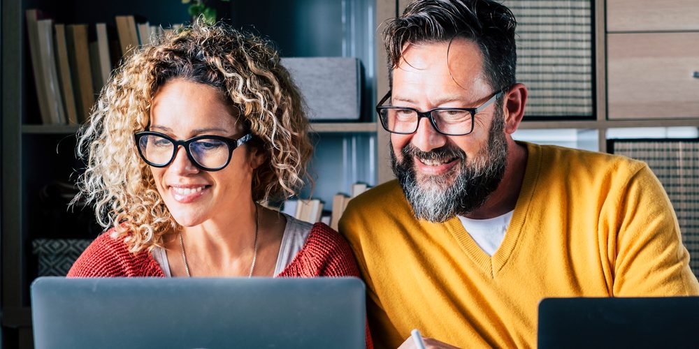 Happy,Man,And,Woman,Couple,Work,At,Home,In,Smart