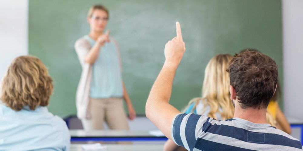 Male,Student,Raising,Hand,In,The,Classroom